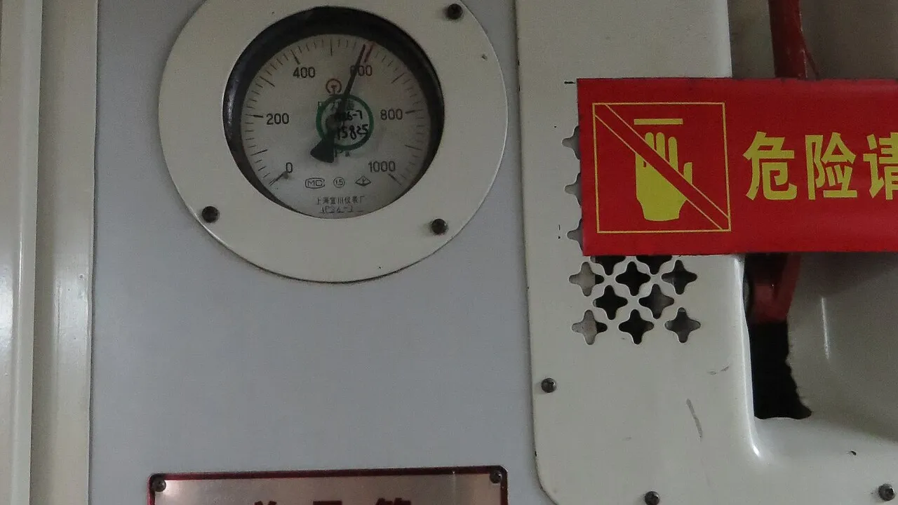 Analog differential pressure gauges on an industrial instrument panel