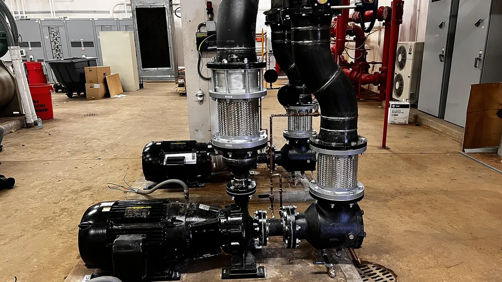 Vertical industrial pumps with pipework and valves in a plant room