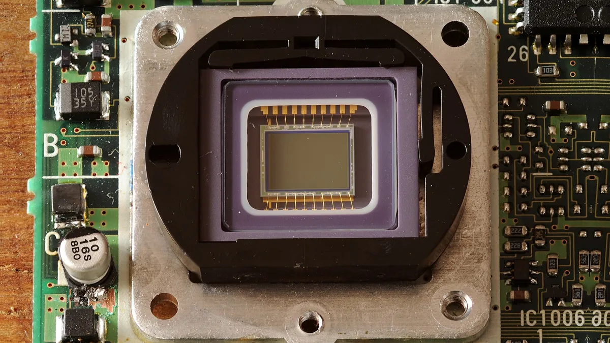 Close-up of a miniature sensor package with surface-mount components