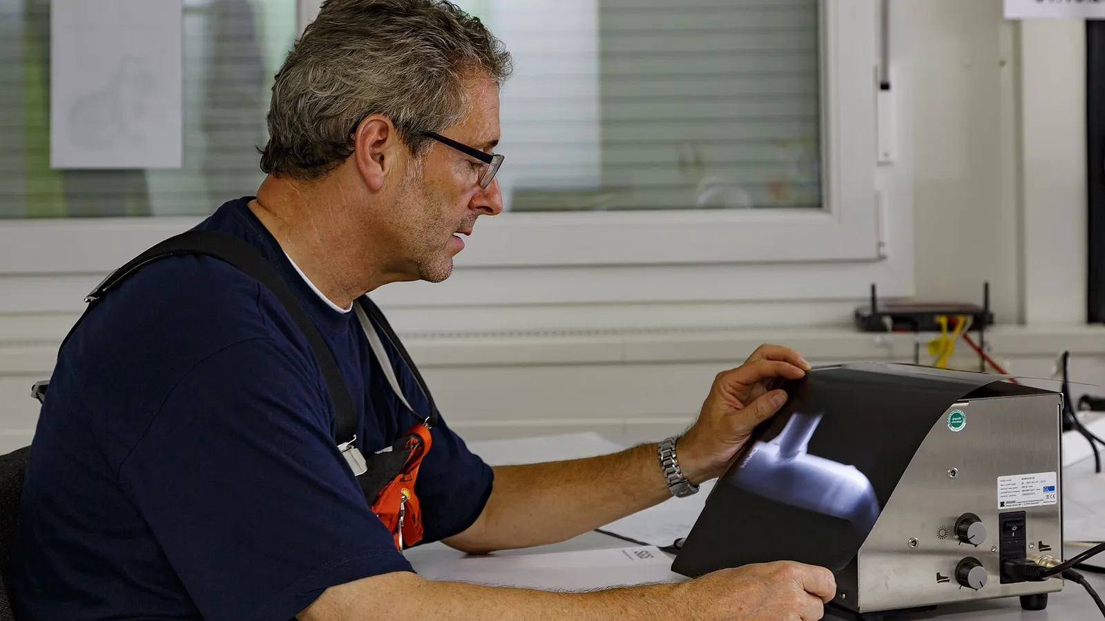 Technician calibrating a pressure instrument at a workbench