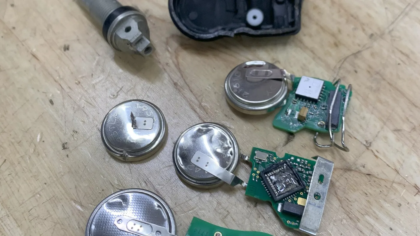 Disassembled pressure transmitter components laid out on a bench
