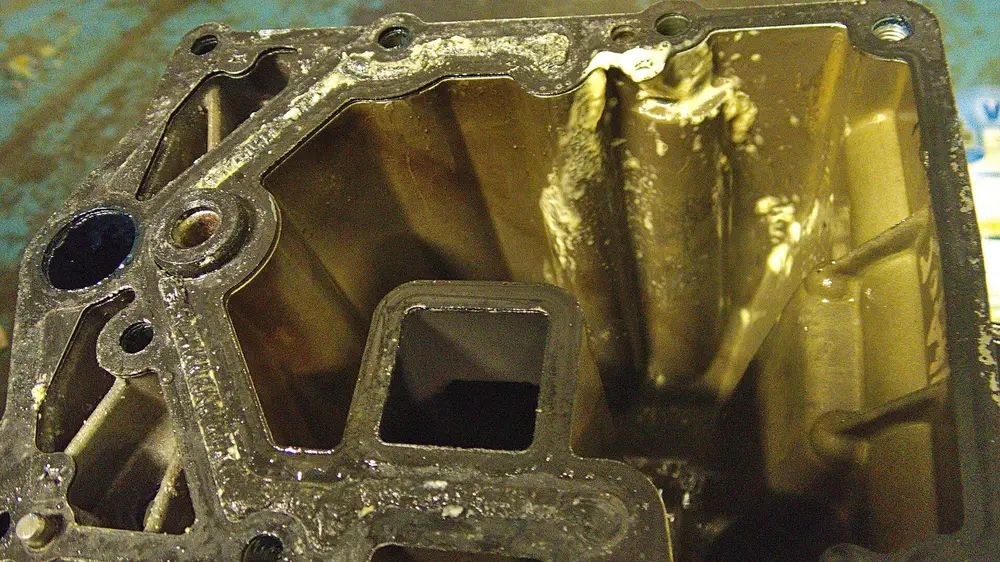 Brass machined pump housing component on a workshop bench