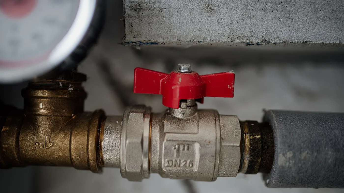 Pressure gauge fitted to a brass valve on an in-service pipe